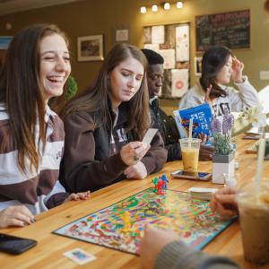 Students playing board game 