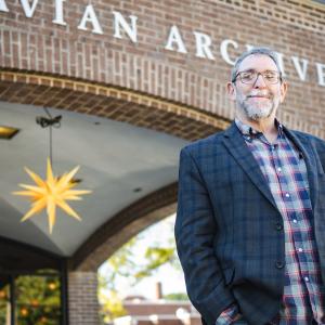 Scott Gordon stands in front of the Moravian Archives building.
